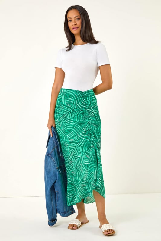 Marked Ruffle Midi Skirt from Roman. Make a stylish statement this Spring/Summer with this marked ruffle skirt. This midi length skirt is designed with a unique ruffle detail that adds a playful touch to your outfit. The side zip fastening ensures a sleek, flattering fit while making it easy to slip on and off. Pair it with a chic cami top and trendy sandals for a fabulous look that's perfect for any sunny day outing!