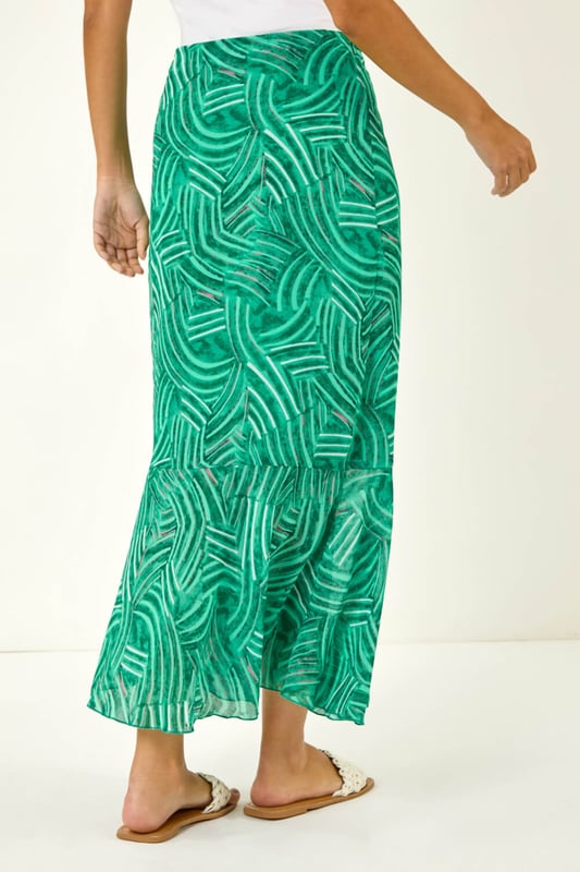 Marked Ruffle Midi Skirt from Roman. Make a stylish statement this Spring/Summer with this marked ruffle skirt. This midi length skirt is designed with a unique ruffle detail that adds a playful touch to your outfit. The side zip fastening ensures a sleek, flattering fit while making it easy to slip on and off. Pair it with a chic cami top and trendy sandals for a fabulous look that's perfect for any sunny day outing!
