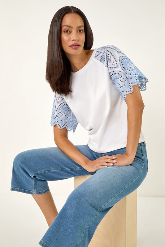 Dusk Broderie Contrast Sleeve Top from Roman. Give your casual wardrobe a stylish update with this contrast sleeve top. Featuring a timeless round neckline and short raglan sleeves with a stunning broderie contrast design. Crafted from a soft, breathable cotton fabric perfect for the Spring Summer season, this top finishes in a flattering tee shape. Pair with a denim jacket and jeggings for a complete look!