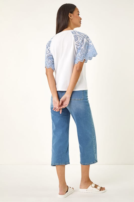 Dusk Broderie Contrast Sleeve Top from Roman. Give your casual wardrobe a stylish update with this contrast sleeve top. Featuring a timeless round neckline and short raglan sleeves with a stunning broderie contrast design. Crafted from a soft, breathable cotton fabric perfect for the Spring Summer season, this top finishes in a flattering tee shape. Pair with a denim jacket and jeggings for a complete look!