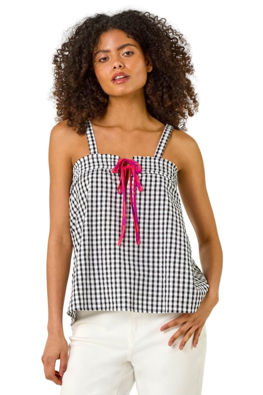 Mono Gingham Cami Top from Roman. This chic cami top features an all over mono gingham print, adding a fresh and timeless pattern to your wardrobe. With a flattering hip-length finish, it’s perfect for layering or wearing on its own. Its lightweight fabric makes it ideal for warmer days, and its versatile design pairs beautifully with jeans, skirts, or shorts for a casual yet stylish look.