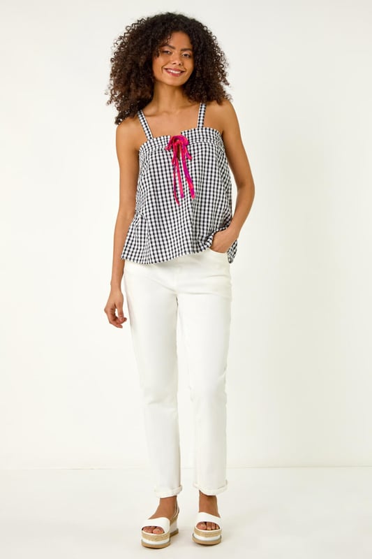 Mono Gingham Cami Top from Roman. This chic cami top features an all over mono gingham print, adding a fresh and timeless pattern to your wardrobe. With a flattering hip-length finish, it’s perfect for layering or wearing on its own. Its lightweight fabric makes it ideal for warmer days, and its versatile design pairs beautifully with jeans, skirts, or shorts for a casual yet stylish look.