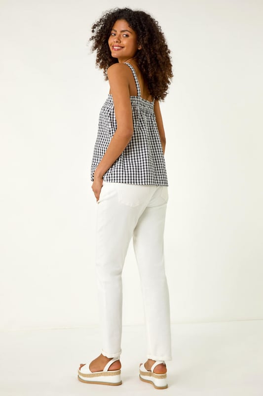 Mono Gingham Cami Top from Roman. This chic cami top features an all over mono gingham print, adding a fresh and timeless pattern to your wardrobe. With a flattering hip-length finish, it’s perfect for layering or wearing on its own. Its lightweight fabric makes it ideal for warmer days, and its versatile design pairs beautifully with jeans, skirts, or shorts for a casual yet stylish look.