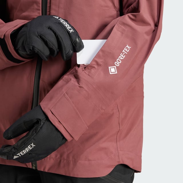 Float through powder and explore the backcountry in a jacket that gives you the freedom to roam. This adidas Terrex ski shell features three-layer GORE-TEX construction with the soft, easy-moving feel of C-Knit backer. Made for layering to match the conditions, it seals out snow, wind and rain while maintaining a lightweight feel and allowing your body to breathe as you search for fresh tracks. A helmet-compatible hood and inner cuffs with thumb loops offer extra coverage on deep, stormy days, while zip pockets keep essentials secure. Open the underarm vents for air as you skin up for the next run. This product is made with at least 70% recycled materials. By reusing materials that have already been created, adidas help to reduce waste and our reliance on finite resources and reduce the footprint of the products adidas make.  -