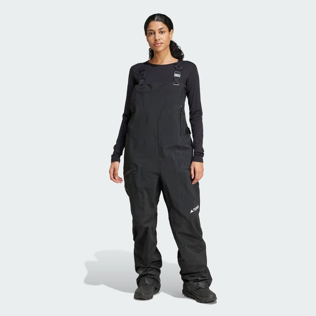 Ride the resort and explore the backcountry in bib pants that give you the freedom to roam. These adidas Terrex snow bibs feature three-layer GORE-TEX construction and the soft, easy-moving feel of C-Knit backer. Made for layering to match the conditions, they offer breathable, storm-sealing coverage while maintaining a lightweight feel and a full range of motion. Reinforced cuffs hold up to ski edges, while built-in boot gaiters seal out snow. Stretch flooce in the back panel maintains an unrestricted range of motion and adds warmth where needed. Two-way leg zips offer venting on the uptrack and make for easy on-and-off, while a drop seat makes for easy bathroom breaks. A mix of pockets, including two thigh pockets and an internal phone pocket, keep must-have stuff close and secure.This product is made with at least 70% recycled materials. By reusing materials that have already been created, adidas help to reduce waste and our reliance on finite resources and reduce the footprint of