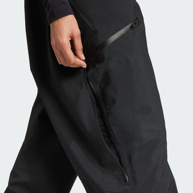 Ride the resort and explore the backcountry in bib pants that give you the freedom to roam. These adidas Terrex snow bibs feature three-layer GORE-TEX construction and the soft, easy-moving feel of C-Knit backer. Made for layering to match the conditions, they offer breathable, storm-sealing coverage while maintaining a lightweight feel and a full range of motion. Reinforced cuffs hold up to ski edges, while built-in boot gaiters seal out snow. Stretch flooce in the back panel maintains an unrestricted range of motion and adds warmth where needed. Two-way leg zips offer venting on the uptrack and make for easy on-and-off, while a drop seat makes for easy bathroom breaks. A mix of pockets, including two thigh pockets and an internal phone pocket, keep must-have stuff close and secure.This product is made with at least 70% recycled materials. By reusing materials that have already been created, adidas help to reduce waste and our reliance on finite resources and reduce the footprint of