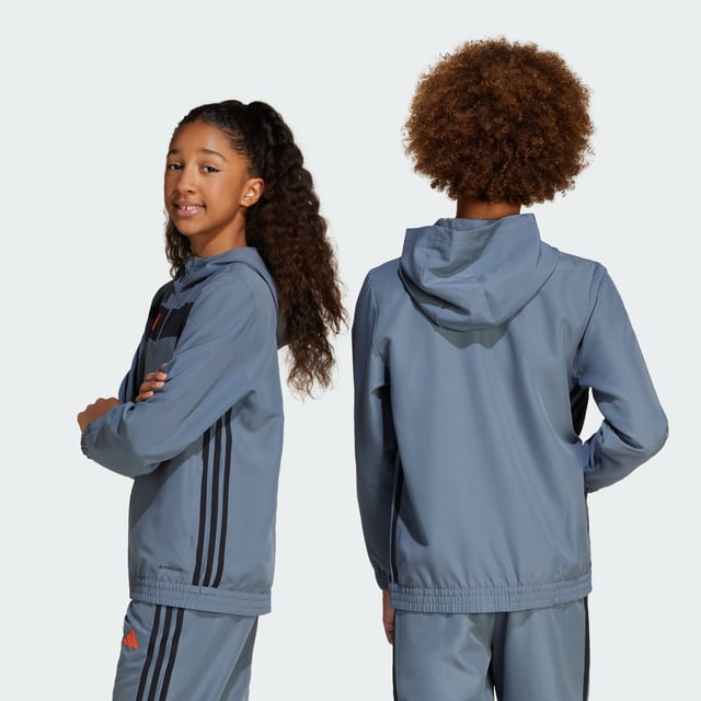 Look like a pro when you're off the field in this juniors' Tiro 25 Essentials hoodie from adidas. Inspired by the beautiful game, this hooded top brings football-inspired style to your everyday wear with bold blocks of colour, a 3 Bar Logo and a pair of signature 3-Stripes. Moisture-managing AEROREADY keeps you dry and comfortable, and two zip pockets secure your essentials.This product is made with 100% recycled materials. By reusing materials that have already been created, adidas help to reduce waste and our reliance on finite resources and reduce the footprint of the products adidas make.  - Regular fit - Full zip with hood - 100% polyester (recycled) - AEROREADY - Zip pockets  Shipped by adidas