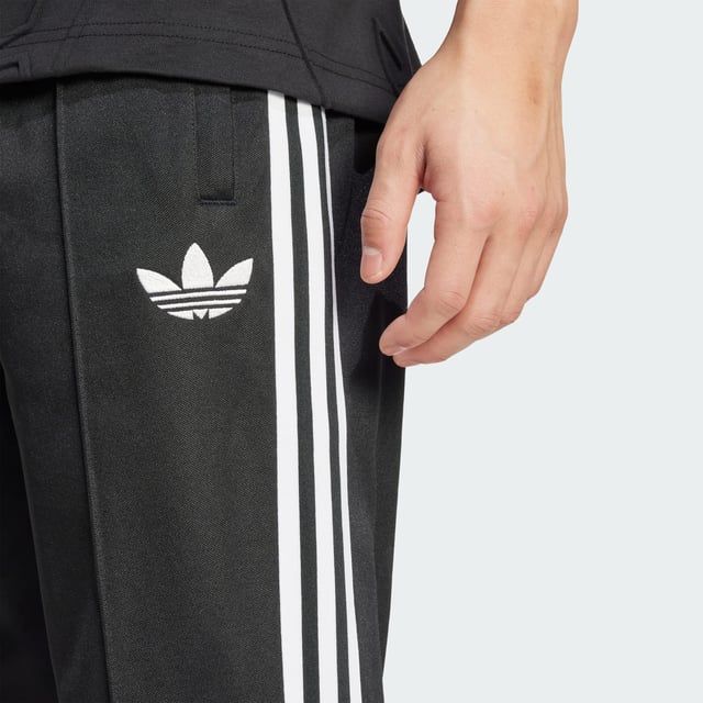 Part of a special collection that commemorates a century of Colo-Colo football. These adidas track pants show off a vintage club badge and iconic Trefoil for a look rooted firmly in football's past. Cut for a slim fit from soft piqué fabric, they'll keep you comfortable in a beloved 3-Stripes silhouette.  - Slim fit - Elastic waist with drawcord - 52% cotton, 48% polyester (recycled) - Front pockets - Colo-Colo crest  Shipped by adidas