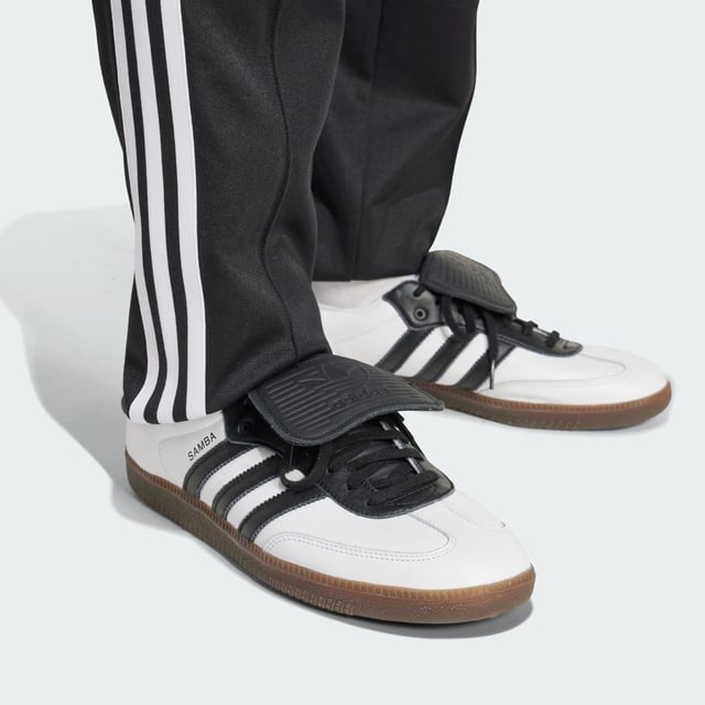 Part of a special collection that commemorates a century of Colo-Colo football. These adidas track pants show off a vintage club badge and iconic Trefoil for a look rooted firmly in football's past. Cut for a slim fit from soft piqué fabric, they'll keep you comfortable in a beloved 3-Stripes silhouette.  - Slim fit - Elastic waist with drawcord - 52% cotton, 48% polyester (recycled) - Front pockets - Colo-Colo crest  Shipped by adidas