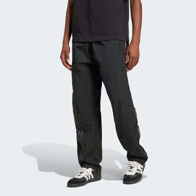Inspired by the 2000s-era archive, these track pants from adidas give you a minimalist look with maximum impact. Long zippers along the sides with airy mesh underneath keep you comfortable with fashion in focus from the moment you pull them on. They have a loose fit with woven fabric that's lightweight yet durable. A floating Trefoil and 3-Stripes down the right leg show your allegiance to the brand with sport heritage.  - Loose fit - Drawcord on elastic waist - 100% polyamide (recycled) - Side-panel zips with mesh underneath  Shipped by adidas