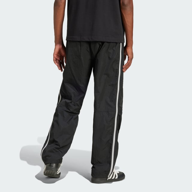 Inspired by the 2000s-era archive, these track pants from adidas give you a minimalist look with maximum impact. Long zippers along the sides with airy mesh underneath keep you comfortable with fashion in focus from the moment you pull them on. They have a loose fit with woven fabric that's lightweight yet durable. A floating Trefoil and 3-Stripes down the right leg show your allegiance to the brand with sport heritage.  - Loose fit - Drawcord on elastic waist - 100% polyamide (recycled) - Side-panel zips with mesh underneath  Shipped by adidas