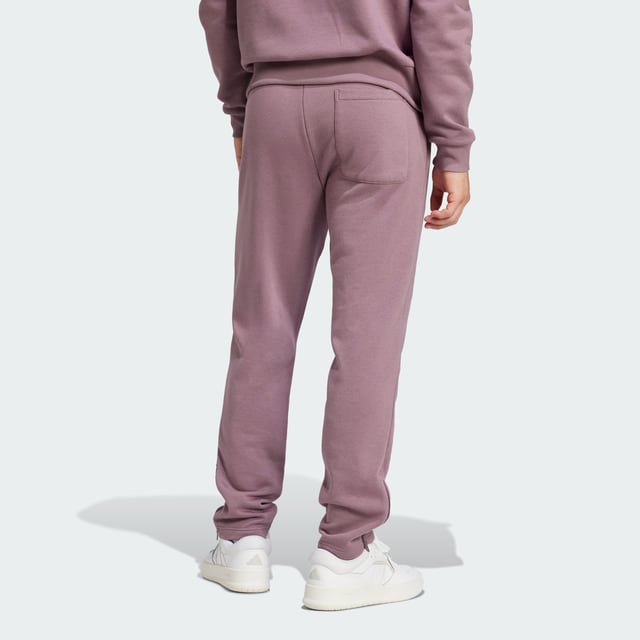 Wherever you go, show your football allegiance in style. Crafted for comfort, these adidas Real Madrid pants are built from soft fleece. Zips keep the fit tucked in at the ankles and a drawcord waist ensures you find the ideal fit. Sewn onto one leg, a club badge shares your team pride.  - Regular fit - Drawcord on elastic waist - 70% cotton, 30% polyester (recycled) - Side pockets - Back patch pocket - Ankle zips - Real Madrid sewn-on crest  Shipped by adidas