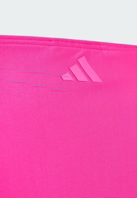 Make a splash in this juniors' adidas bikini. The stylish two-piece suit features an outlined 3 Bar Logo front and centre, showcasing your adidas pride. Underbust elastic provides extra support for swimming and other water sports. This product is made with at least 70% recycled materials. By reusing materials that have already been created, adidas help to reduce waste and our reliance on finite resources and reduce the footprint of the products adidas make.  - Tight fit - 78% polyester (recycled), 22% elastane - Lined gusset - Infinitex fabric  Shipped by adidas