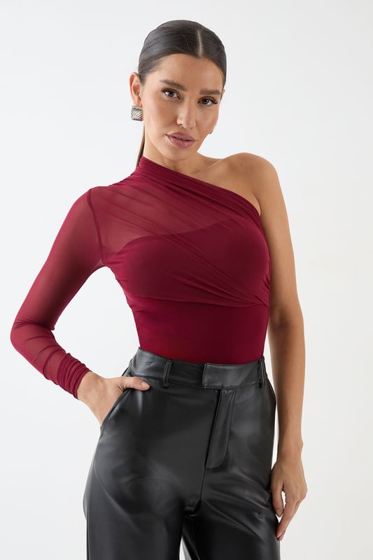 Mesh One Shoulder Bodysuit Striking one-shoulder design for a bold, asymmetric look
Sheer mesh long sleeve adds allure and intrigue
Figure-hugging bodysuit silhouette for a sleek fit
Versatile piece that can be dressed up or down
Perfect for making a statement on nights out
Make heads turn in this daring mesh one-shoulder bodysuit from MissPap. The asymmetric neckline and sheer long sleeve create a captivating contrast, while the form-fitting silhouette accentuates your curves. For a night out on the town, pair it with high-waisted wide-leg jeans and statement heels to create a look that's both edgy and chic. Add some sparkle with bold earrings and a metallic clutch. When it's time to hit the dance floor, swap the jeans for a sleek mini skirt and strappy sandals. This versatile piece can also be layered under a blazer for a more sophisticated ensemble. Whether you're heading to a trendy bar or a pulsing nightclub, this bodysuit ensures you'll be the centre of attention all night long.