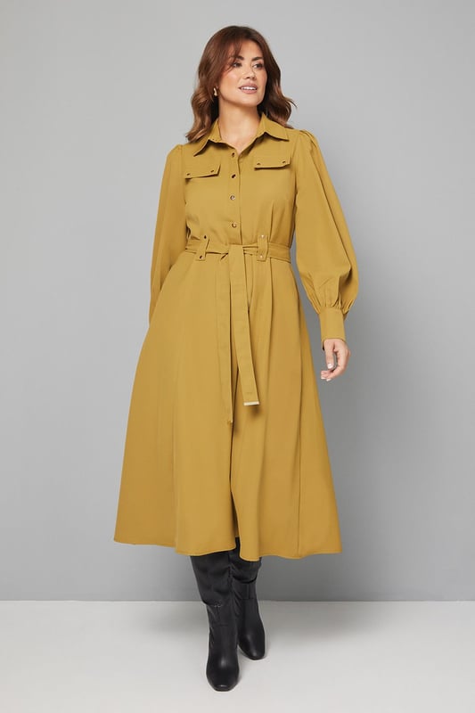 Elegant midi dress crafted from lightweight crepe fabric for comfortable all-day wear
        Sophisticated collared neckline with button-through front design for classic appeal
        Statement balloon sleeves with neat cuffs adding a contemporary touch to a timeless silhouette
        Practical chest pockets providing both style and functionality
        Flattering belted waist that cinches and defines your figure beautifully
    
    This versatile Wallis midi dress combines sophistication with everyday wearability. The flowing crepe fabric drapes elegantly while the belted waist creates a flattering silhouette that works for various body types. Style with knee-high boots as shown for an effortlessly chic daytime look perfect for lunch dates or family gatherings. For a more casual approach, pair with white trainers and a denim jacket. The practical pocket details and comfortable fit make this an ideal choice for busy days when you need to look polished without sacrificing comfort. Transition from day to evening by swapping boots for ballet flats and adding statement earrings. This dress will quickly become a cornerstone of your wardrobe, offering endless styling possibilities throughout the seasons.