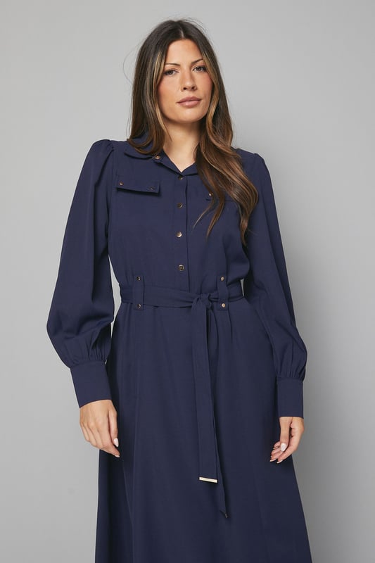 Elegant midi dress crafted from lightweight crepe fabric for comfortable all-day wear
        Sophisticated collared neckline with button-through front design for classic appeal
        Statement balloon sleeves with neat cuffs adding a contemporary touch to a timeless silhouette
        Practical chest pockets providing both style and functionality
        Flattering belted waist that cinches and defines your figure beautifully
    
    This versatile Wallis midi dress combines sophistication with everyday wearability. The flowing crepe fabric drapes elegantly while the belted waist creates a flattering silhouette that works for various body types. Style with knee-high boots as shown for an effortlessly chic daytime look perfect for lunch dates or family gatherings. For a more casual approach, pair with white trainers and a denim jacket. The practical pocket details and comfortable fit make this an ideal choice for busy days when you need to look polished without sacrificing comfort. Transition from day to evening by swapping boots for ballet flats and adding statement earrings. This dress will quickly become a cornerstone of your wardrobe, offering endless styling possibilities throughout the seasons.