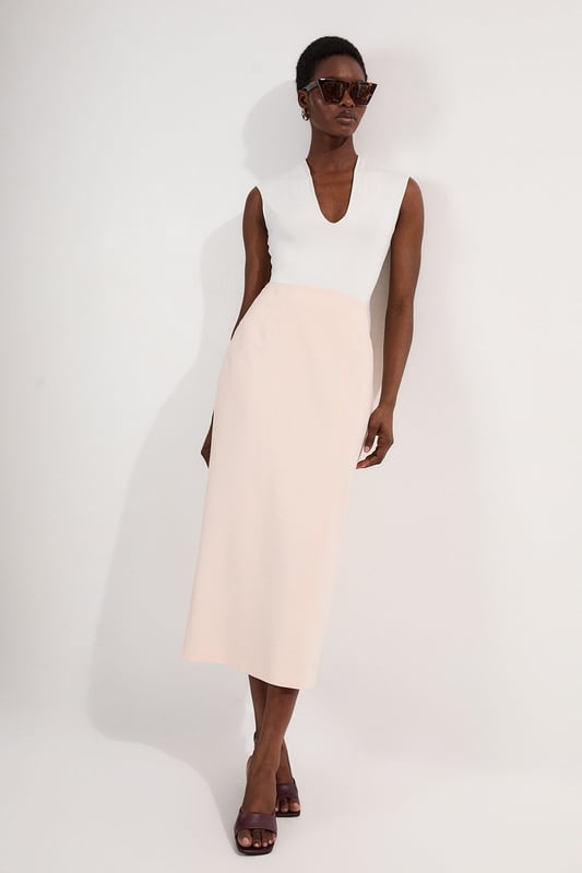 This Karen Millen tailored midi pencil skirt offers the perfect balance of sophistication and practicality for your everyday wardrobe. The compact stretch fabric moulds to your silhouette whilst ensuring all-day comfort and ease of movement. Style with a crisp sleeveless top and strappy sandals for a refined daytime look, or pair with a structured blazer for an effortlessly stylish ensemble perfect for family gatherings or lunch with friends. The functional pocket detail adds a contemporary touch to this timeless piece, whilst the below-knee length creates a flattering line that works brilliantly with both flats and low heels. This versatile skirt can be dressed down with a casual knit and trainers for weekend brunches or styled with a silk blouse for more polished daywear occasions.  Sleek midi pencil skirt Practical side pocket detail Elegant midi length Versatile design