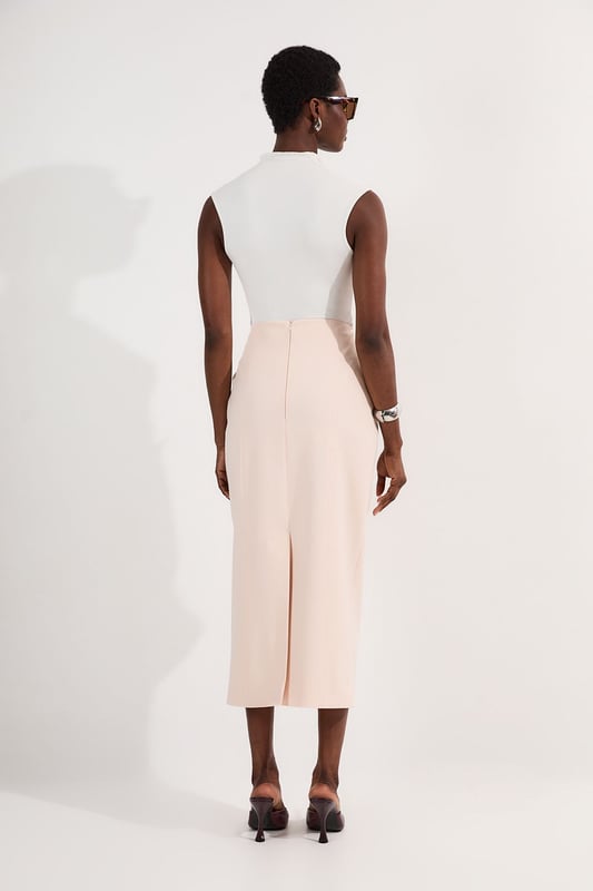 This Karen Millen tailored midi pencil skirt offers the perfect balance of sophistication and practicality for your everyday wardrobe. The compact stretch fabric moulds to your silhouette whilst ensuring all-day comfort and ease of movement. Style with a crisp sleeveless top and strappy sandals for a refined daytime look, or pair with a structured blazer for an effortlessly stylish ensemble perfect for family gatherings or lunch with friends. The functional pocket detail adds a contemporary touch to this timeless piece, whilst the below-knee length creates a flattering line that works brilliantly with both flats and low heels. This versatile skirt can be dressed down with a casual knit and trainers for weekend brunches or styled with a silk blouse for more polished daywear occasions.  Sleek midi pencil skirt Practical side pocket detail Elegant midi length Versatile design