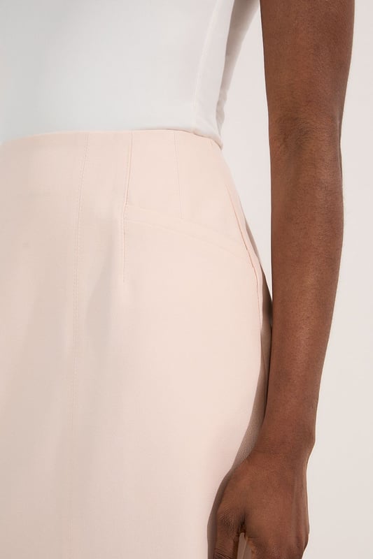 This Karen Millen tailored midi pencil skirt offers the perfect balance of sophistication and practicality for your everyday wardrobe. The compact stretch fabric moulds to your silhouette whilst ensuring all-day comfort and ease of movement. Style with a crisp sleeveless top and strappy sandals for a refined daytime look, or pair with a structured blazer for an effortlessly stylish ensemble perfect for family gatherings or lunch with friends. The functional pocket detail adds a contemporary touch to this timeless piece, whilst the below-knee length creates a flattering line that works brilliantly with both flats and low heels. This versatile skirt can be dressed down with a casual knit and trainers for weekend brunches or styled with a silk blouse for more polished daywear occasions.  Sleek midi pencil skirt Practical side pocket detail Elegant midi length Versatile design