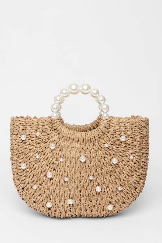 - Woven finish - Pearl details - Top handle - Lined - Exterior: 100% paper; excluding trims - Lining: 100% polyester
