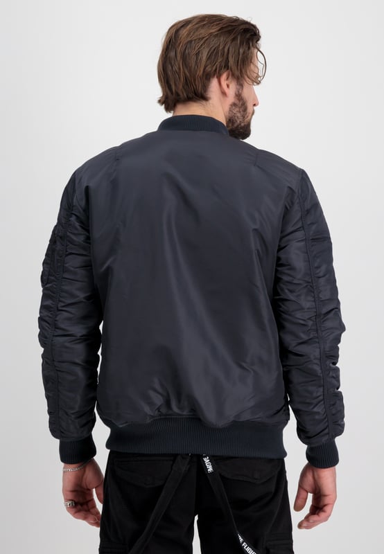 We present the MA-1 VF 59 Long bomber jacket from Alpha Industries. This stylish and comfortable jacket is perfect for men who desire a slim fit with a longer cut. It features an orange lining and a pencil pocket for added convenience.