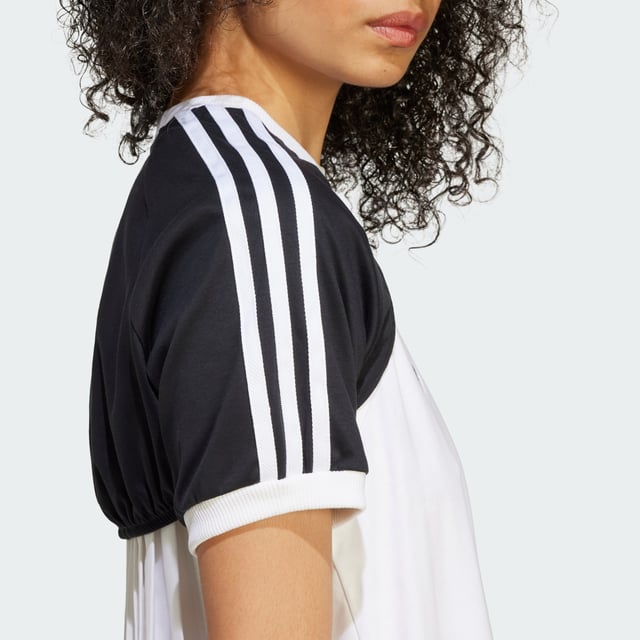 The adidas Originals R3CD Cali Tee goes for a more casual, laid-back aesthetic. Encouraging play with your style, there are two layers in one — first the tank top with details that call on the '90s and early aughts, then the over layer which can easily be mixed and matched with other pieces in your wardrobe. The back of the tank top is crafted with pleated woven fabric, while the front is a classic ribbed material.  - Slim fit - Part A: Ribbed crewneck - 53% cotton, 47% polyester (recycled) - Part A: Ribbed cuffs - Two-piece construction  Shipped by adidas