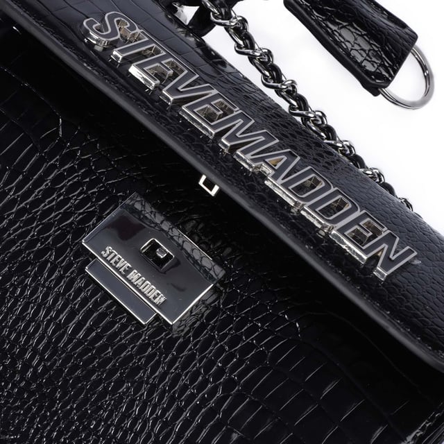 Adjustable shoulder strap.One main compartment.Closes with plug fastener.Slip pocket on the back.One zip pocket.One slip pocket.Divider with zip pocket.Detachable pendant.