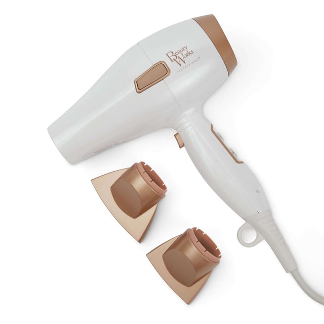 Experience salon-quality results at home with the Beauty Works Hair Dryer Kit. This powerful dryer features a 1935-2300W brushless DC motor that reduces drying time while delivering smooth, shiny hair. The ionic conditioning technology eliminates frizz, leaving your hair healthier and manageable. Customize your drying experience with three heat settings and two speed options, plus a cool shot for lasting styles. The kit includes two concentrator nozzles for precision styling and a ceramic brush for easy sectioning. Complete with a stylish dust bag for storage.