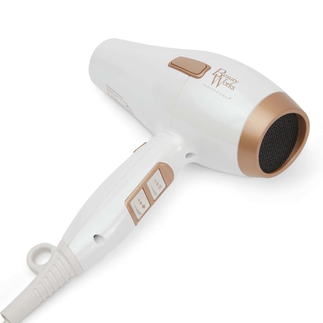 Experience salon-quality results at home with the Beauty Works Hair Dryer Kit. This powerful dryer features a 1935-2300W brushless DC motor that reduces drying time while delivering smooth, shiny hair. The ionic conditioning technology eliminates frizz, leaving your hair healthier and manageable. Customize your drying experience with three heat settings and two speed options, plus a cool shot for lasting styles. The kit includes two concentrator nozzles for precision styling and a ceramic brush for easy sectioning. Complete with a stylish dust bag for storage.