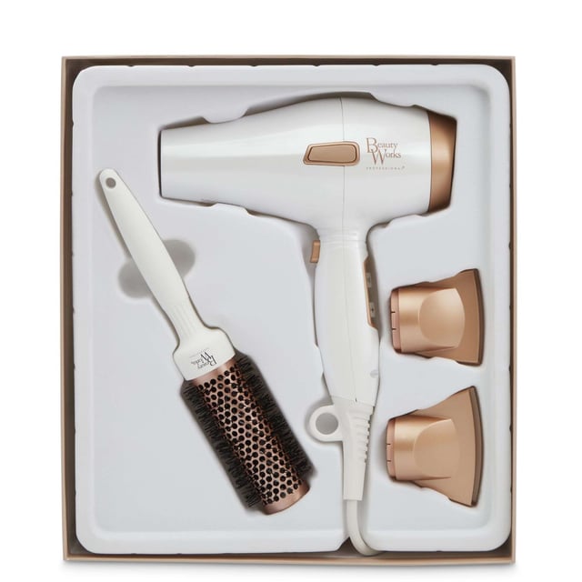 Experience salon-quality results at home with the Beauty Works Hair Dryer Kit. This powerful dryer features a 1935-2300W brushless DC motor that reduces drying time while delivering smooth, shiny hair. The ionic conditioning technology eliminates frizz, leaving your hair healthier and manageable. Customize your drying experience with three heat settings and two speed options, plus a cool shot for lasting styles. The kit includes two concentrator nozzles for precision styling and a ceramic brush for easy sectioning. Complete with a stylish dust bag for storage.