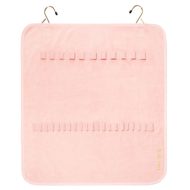 Simplify your brush cleaning routine with the Spectrum Makeup Brush Drying Towel. This innovative towel features convenient elasticated slots to securely hold your brushes while they dry. After washing your brushes, simply dry off excess water on the towel, place the brushes in the slots, and hang it in a warm area using the included metal hooks. Perfect for easy hanging on doors or solid surfaces, or for rolling up and transporting your freshly cleaned brushes. Remember to hang with brush heads down to protect the glue that holds the brush heads in place.
