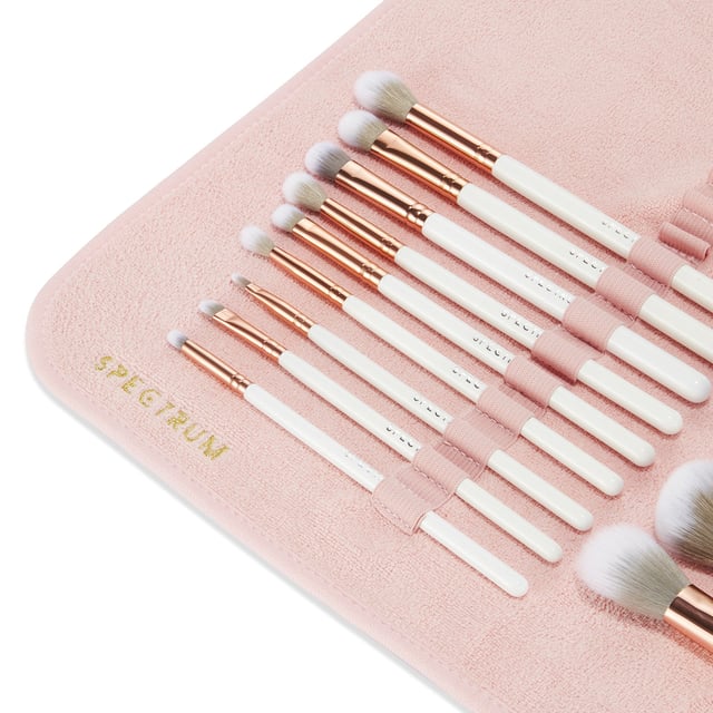 Simplify your brush cleaning routine with the Spectrum Makeup Brush Drying Towel. This innovative towel features convenient elasticated slots to securely hold your brushes while they dry. After washing your brushes, simply dry off excess water on the towel, place the brushes in the slots, and hang it in a warm area using the included metal hooks. Perfect for easy hanging on doors or solid surfaces, or for rolling up and transporting your freshly cleaned brushes. Remember to hang with brush heads down to protect the glue that holds the brush heads in place.