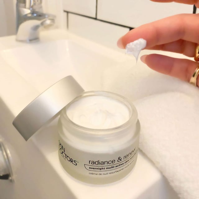 Transform your skin overnight with Skin Doctors Radiance & Renew Multi-Active Resurfacing Cream. This powerful, one-step treatment gently exfoliates the top layer of dead skin, revealing a youthful and radiant complexion. Ideal for addressing signs of aging, uneven skin texture, pigmentation, and blemishes, this cream utilizes a blend of alpha and beta hydroxy acids for a professional-grade resurfacing effect. Designed for all skin types, simply apply a thin layer before bed and wake up to rejuvenated skin. Experience the difference in your skin's clarity and brightness.
