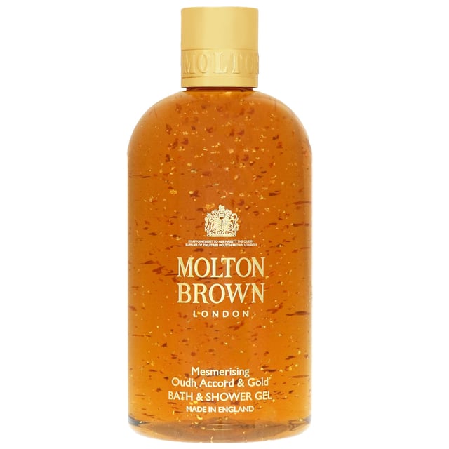 Indulge in the luxurious experience of Molton Brown's Mesmerising Oudh Accord & Gold Bath & Shower Gel. This unisex gel refreshes and purifies your skin while enveloping you in a captivating fragrance blend of cinnamon leaf, nutmeg, bergamot, elemi, myrrh, black tea, oudh, vetiver, and honey. Perfect for daily use, it transforms your bathing routine into a spa-like experience. Trust in Molton Brown, a cruelty-free brand approved by Leaping Bunny, to provide you with high-quality bath essentials. Enjoy the richness of this 300 ml gel and elevate your body care today.