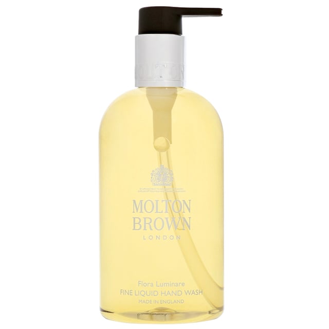 Indulge in the luxury of Molton Brown Flora Luminare Hand Wash, a premium skin cleanser that transforms your hand-washing routine. This exquisite product captures the essence of tropical landscapes with its radiant solar-floral fragrance. Experience a delightful blend of bitter almond, mandarin, olibanum, and petitgrain, leading to a heart of tiare absolute and jasmine. The earthy base notes of sandalwood and musk complete this sensory experience. Perfect for women, this cruelty-free hand wash is a must-have addition to your bath collection.