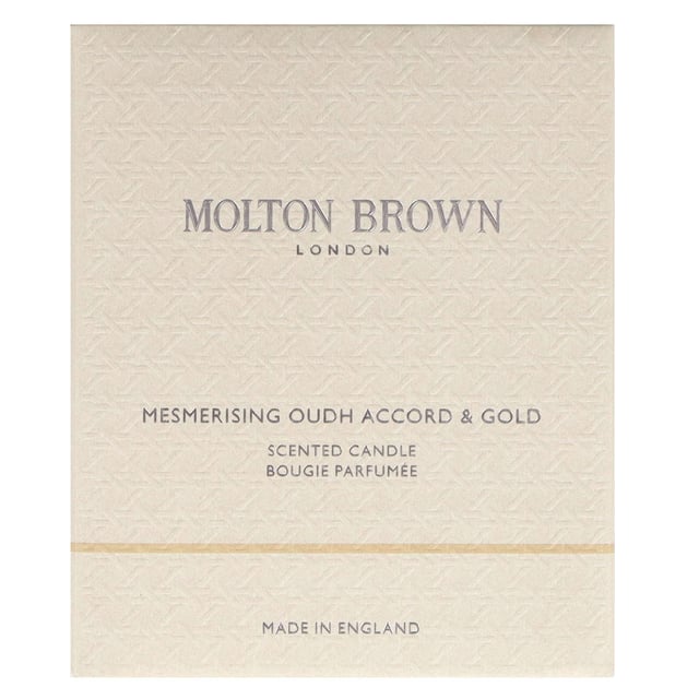Luxurious Molton Brown Oudh Accord & Gold Candle - 190g Indulge in the opulent aroma of the Molton Brown Oudh Accord & Gold Candle, expertly crafted to elevate your space. Launched in 2015, this enchanting candle features a harmonious blend of spicy top notes of cinnamon leaf, nutmeg, and bergamot, complemented by rich middle notes of elemi, myrrh, and black tea. The warm base notes of oudh, vetiver, and honey create a truly captivating experience. Each candle is 190g and embodies the cruelty-free ethos of the Leaping Bunny approved Molton Brown brand, making it an exquisite gift or self-care treat.