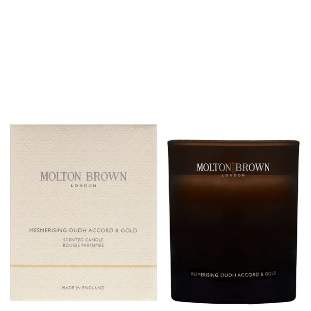 Luxurious Molton Brown Oudh Accord & Gold Candle - 190g Indulge in the opulent aroma of the Molton Brown Oudh Accord & Gold Candle, expertly crafted to elevate your space. Launched in 2015, this enchanting candle features a harmonious blend of spicy top notes of cinnamon leaf, nutmeg, and bergamot, complemented by rich middle notes of elemi, myrrh, and black tea. The warm base notes of oudh, vetiver, and honey create a truly captivating experience. Each candle is 190g and embodies the cruelty-free ethos of the Leaping Bunny approved Molton Brown brand, making it an exquisite gift or self-care treat.