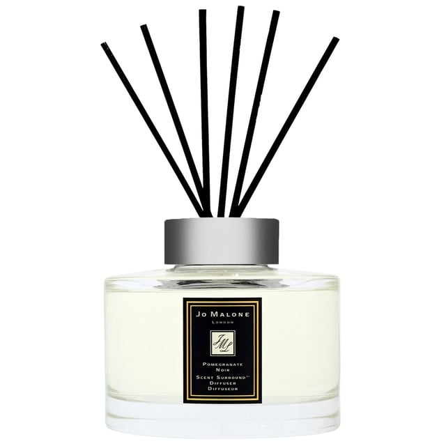 Transform your living space with the exquisite Jo Malone Pomegranate Noir Diffuser. Launched in 2005, this captivating fragrance features a delightful blend of fruity pomegranate, delicate Casablanca lily, and a warm, smoky base of guaiacwood. Experience a harmonious atmosphere with every breath, perfect for enhancing your home or gifting to a loved one. Please note that we cannot ship fragrances over 150ml outside of the UK, and packaging may vary. Indulge in this luxurious scent and elevate your surroundings today.