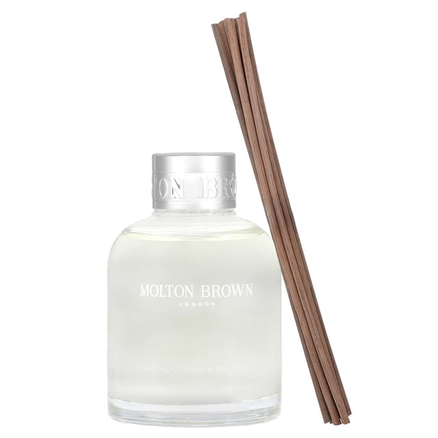 Molton Brown Coastal Cypress & Sea Fennel Aroma Reeds Diffuser - 150ml Transform your space with the Molton Brown Coastal Cypress & Sea Fennel Aroma Reeds Diffuser. Launched in 2017, this exquisite fragrance features top notes of fig leaves, cardamom, and bergamot, complemented by middle notes of jasmine, violet leaf, and marine elements. The base notes of salted cypress, cedarwood, and musk create a rich, inviting scent that evokes the essence of the ocean. Simply allow the reeds to absorb the fragrant oil and place them in a central location to fill your room with this refreshing aroma. Experience luxury with Molton Brown, a cruelty-free brand.