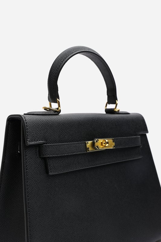 Elevate your everyday ensemble with this Lluvia Top Handle Satchel Mini Tote Bag, a timeless choice for modern elegance. Featuring a structured silhouette and refined grain-textured finish, this handbag blends style and practicality effortlessly. The polished gold-tone turn-lock closure adds a touch of sophistication. Ideal for work or weekend outings, it’s compact yet roomy enough for your essentials. Key Features: • Material: Textured faux leather with contrast stitching • Dimensions: 25cm (L) x 20cm (H) x 11cm (W) • Fastening: Gold-tone turn-lock flap closure • Detail: Minimalist top handle design with structured base and sleek finish 