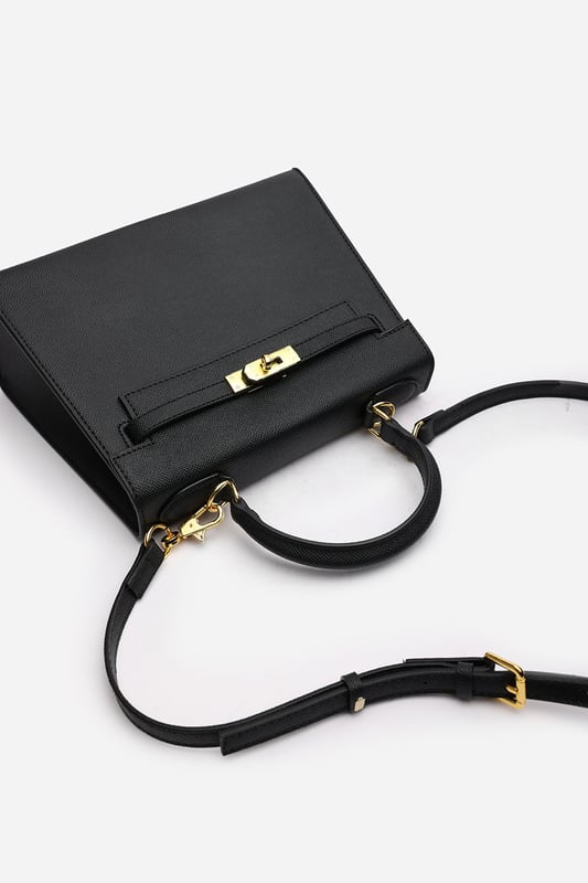 Elevate your everyday ensemble with this Lluvia Top Handle Satchel Mini Tote Bag, a timeless choice for modern elegance. Featuring a structured silhouette and refined grain-textured finish, this handbag blends style and practicality effortlessly. The polished gold-tone turn-lock closure adds a touch of sophistication. Ideal for work or weekend outings, it’s compact yet roomy enough for your essentials. Key Features: • Material: Textured faux leather with contrast stitching • Dimensions: 25cm (L) x 20cm (H) x 11cm (W) • Fastening: Gold-tone turn-lock flap closure • Detail: Minimalist top handle design with structured base and sleek finish 