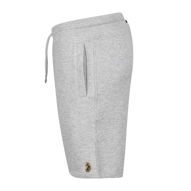 65% Katoen, 35% Polyester. Stof: Fleece. Ontwerp: Geborduurd logo. Zakken: 2 Zijzakken, 1 Achterzak, Rits. Taille: Elastisch, binnenkoord. Taps toelopend, Sierdetail. Pasvorm: Plus.