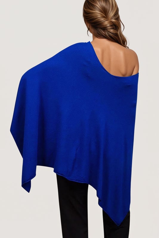 This gorgeous soft knit poncho from Betty Barclay is made from a fine viscose blend knit. In a royal blue hue, this poncho can be worn as a slash neck or cowl neck (simply turn around) and is the perfect cover for summer evenings, or winter parties.
Smooth Fine Knit
Wide Slash Neck
Front 18" Back 29" Shoulder to Hem
These are end of line ex Betty Barclay.