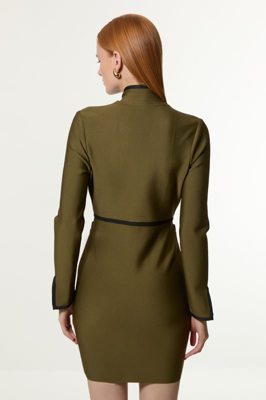 Feel elegant in our mini dress, with a figure hugging silhouette, trim detailing, and contrasting metallic hardware. Style this dress with tiights and heels for an outfit that will turn heads from office days to upcoming occasions and events. Figure Form Bandage Knit Piping Detail Military Dress High Quality Knit Fabric Contrasting, Piped Detailing Metallic Hardware Accents Flattering Fit and Flare Silhouette Formal High Neckline Bodycon Silhouette Zip Front Fastening
