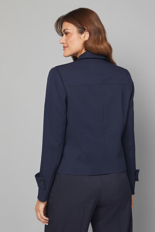 Structured utility jacket featuring four practical front pockets with button closures
        Classic collared neckline with smart lapels for a sophisticated silhouette
        Button-through front fastening with contrasting buttons for added detail
        Tailored regular fit with slight stretch for comfortable all-day wear
        Neat cuff detailing with button accents for a polished finish
    
    This versatile Four Pocket Utility Jacket from Wallis combines practicality with sophisticated style. The structured silhouette offers a flattering shape whilst maintaining comfort through its regular fit and slight stretch. Style with wide-leg denim trousers and a simple white tee for an effortlessly chic daytime look, perfect for weekend brunches or casual shopping trips. Add a leather belt to define the waist and complement with ankle boots for a coordinated ensemble. The neutral tone makes this jacket an excellent layering piece for transitional weather, working beautifully over lightweight jumpers or simple tops. For family gatherings or lunch dates, pair with tailored trousers and ballet flats for a smart-casual outfit that conveys understated elegance. This jacket will quickly become a cornerstone of your casual wardrobe, offering both functionality and style.