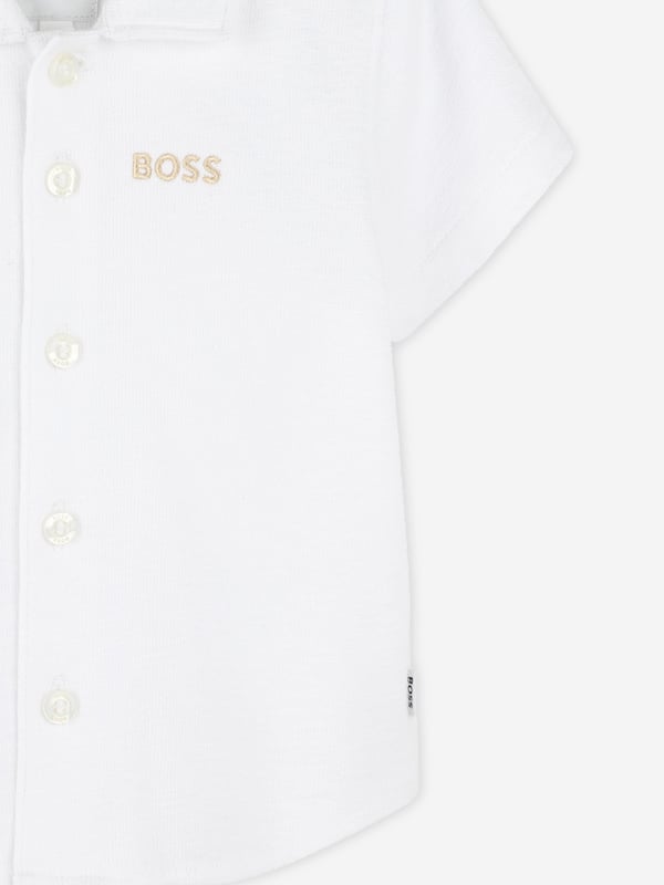 Introduce a touch of elegance to your little gentlemans wardrobe with the BOSS Baby Boys Short Sleeve Shirt in White, crafted for SS2025. Exquisitely tailored by BOSS, this shirt is a luxurious staple for any young wardrobe. Essentials include Elegant Design Classic white hue, ensuring timeless style. Luxurious Comfort Fabricated with premium, soft materials, perfect for delicate skin. Versatile Style Ideal for special occasions or casual playdates.Elevate your little ones ensemble with this sophisticated piece from BOSS a true blend of comfort and class.