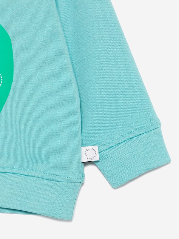 Stella McCartney portray a vibrant aesthetic via their cool and beautifully crafted designs. This baby boys aqua sweatshirt is woven from organic brushed cotton. It is embellished with frog print and a statement logo on the front for a cute and savvy designer style. There is a snap button fastening on the back to provide easy dressing. Long Sleeves Crew Neck Ribbed Cuffs and Hem 100 Organic Cotton