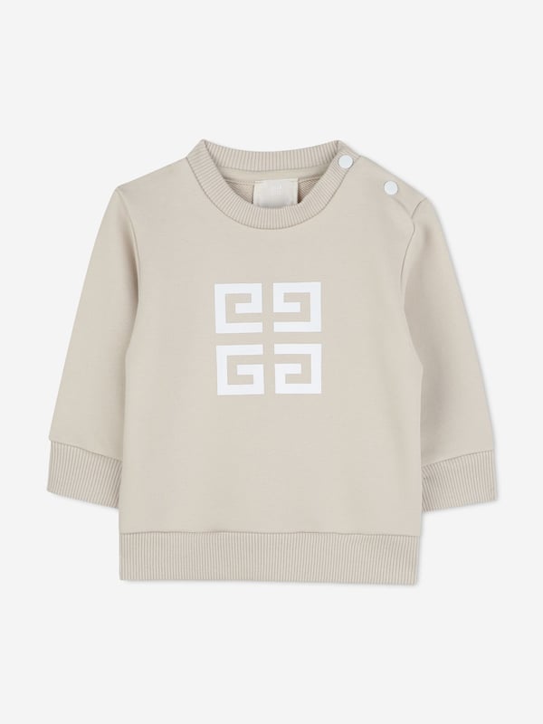 Givenchy incorporate sleek, enigmatic qualities into their lavish French abstracts. This baby boys cream sweatshirt is a Parisian staple piece to adore. Crafted from beautiful high quality cotton. It features a four '4G' print on the centre front via delicate ribbed trims. Round Neck Ribbed Trims Long Sleeves 85 Cotton, 15 Polyester