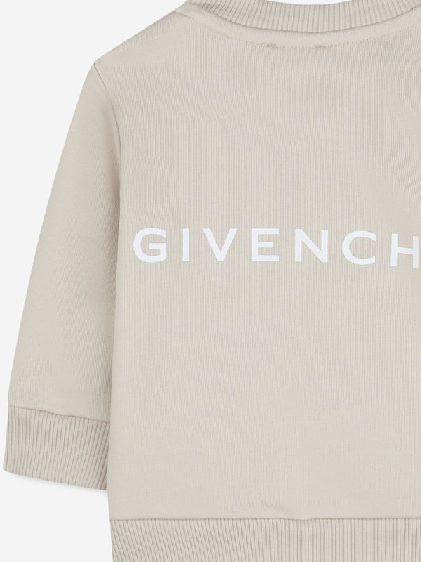 Givenchy incorporate sleek, enigmatic qualities into their lavish French abstracts. This baby boys cream sweatshirt is a Parisian staple piece to adore. Crafted from beautiful high quality cotton. It features a four '4G' print on the centre front via delicate ribbed trims. Round Neck Ribbed Trims Long Sleeves 85 Cotton, 15 Polyester
