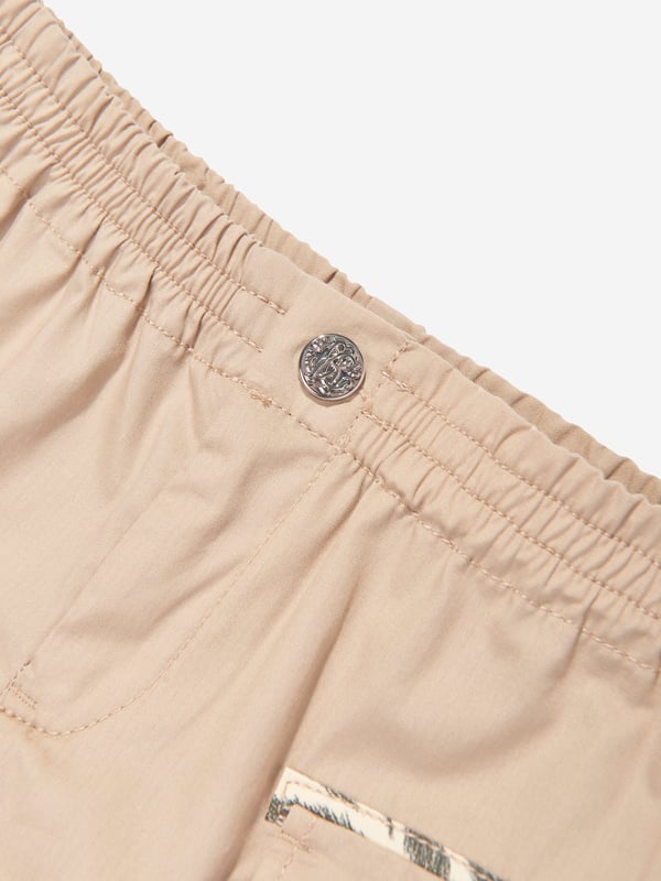 Introducing the exquisite Roberto Cavalli Baby Boys Cargo Shorts in Beige the pinnacle of luxury for your little gentleman's SS2025 wardrobe Italian Craftsmanship Expertly tailored in Italy, embodying unmatched quality and sophistication. Classic Hue Understated beige colour, ensuring versatility and timeless charm. Premium Fabric Constructed with the finest materials for unrivalled comfort and durability.Elevate your child's style with these impeccable Roberto Cavalli cargo shorts. Order now and embrace elegance!